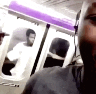 a man wearing headphones is taking a selfie on a train .