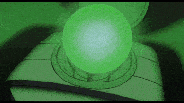 a green ball is glowing in the dark on top of a toilet