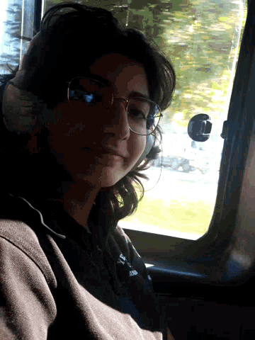 a woman wearing glasses and a shirt that says ' i love you ' on it