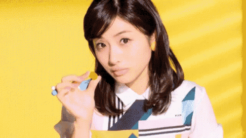 a woman is eating a piece of food with a spoon .
