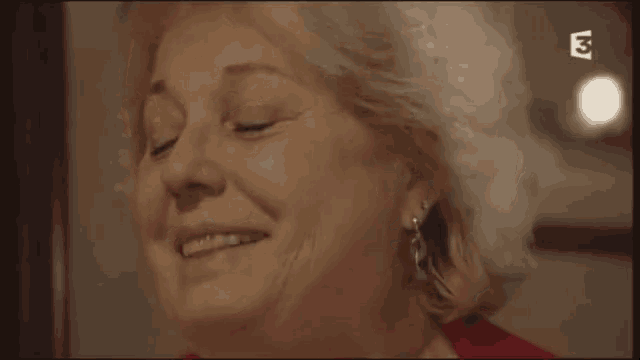 a close up of a woman 's face with the letters ea on the bottom
