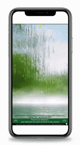 a cell phone displays a screen with a green background and a green arrow pointing to the right