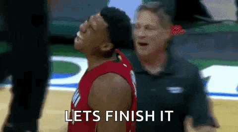 a basketball player is standing next to a referee on a basketball court and says `` lets finish it '' .