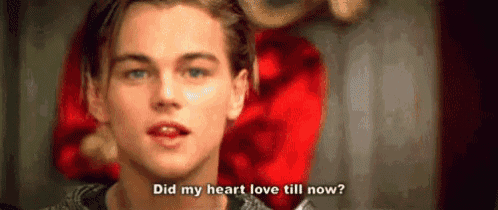 a close up of a man 's face with a red heart in the background .
