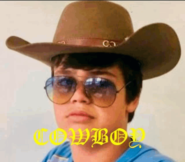 a young boy wearing a cowboy hat and sunglasses with the word cowboy written in yellow