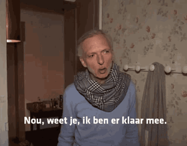 a man with a scarf around his neck says nou weet je