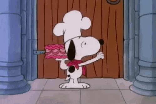 snoopy is wearing a chef 's hat and scarf while holding a piece of cake .