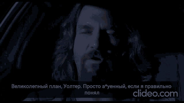 a man in a car with a clipeo.com watermark on the bottom right