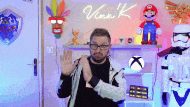 a man stands in front of a neon sign that says ' vinne k '