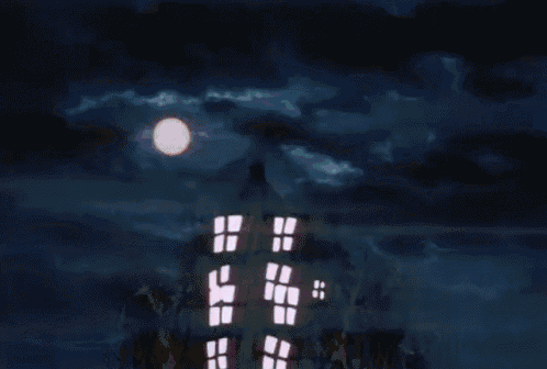 a full moon shines brightly in a cloudy night sky