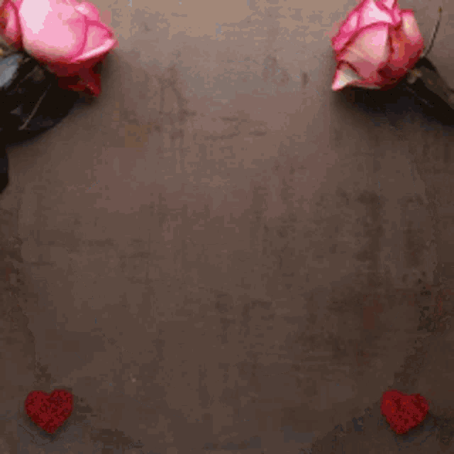 a plate of cookies with a heart shaped filling on a table with roses .