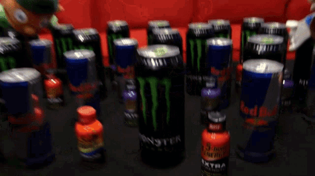 a bunch of cans of monster energy drinks