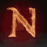 the letter n is surrounded by flames on a dark background .