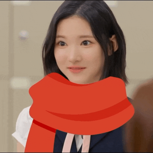 a girl with a red scarf around her neck looks at the camera