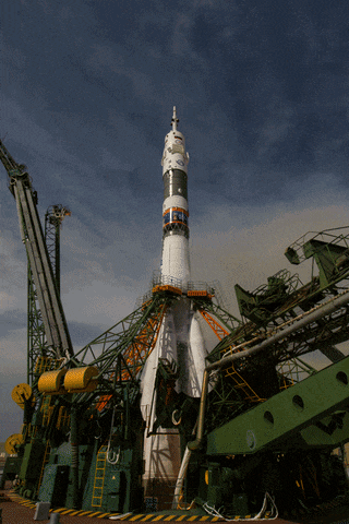 a rocket with a clock on top of it that says ' sputnik ' on it