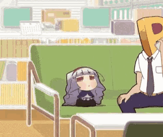 a man is sitting on a green couch with a paper bag over his head