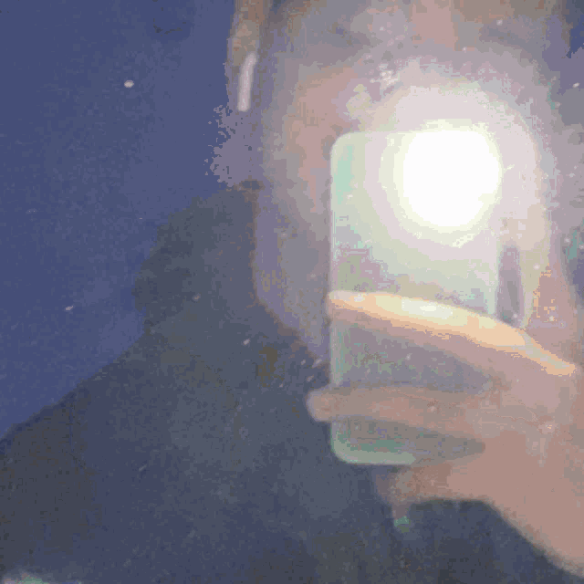 a person taking a picture of themselves with their phone