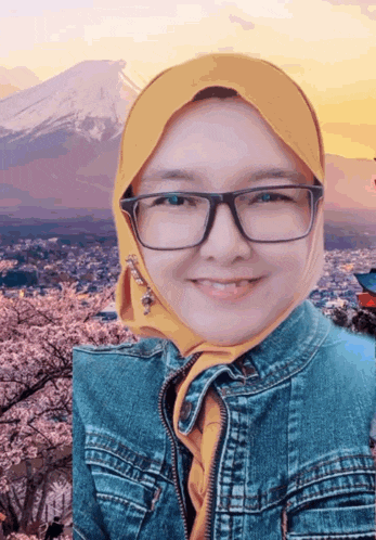 a woman wearing glasses and a yellow head scarf