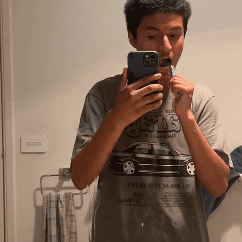a man taking a picture of himself in a mirror with a shirt that says 6916 on it