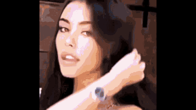 a woman is wearing a watch on her wrist .