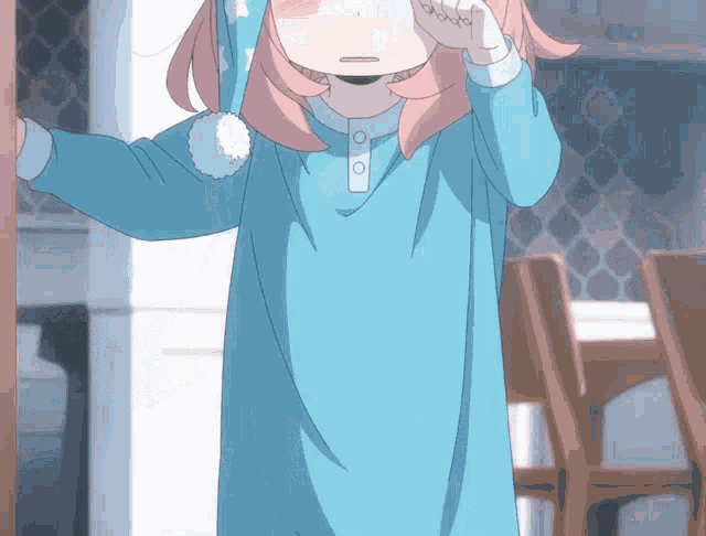 a little girl with pink hair is wearing a blue shirt