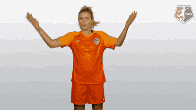 a female soccer player wearing an orange shirt and shorts with the letters snf on the front