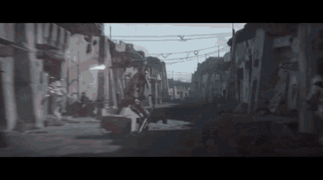 a person is riding a motorcycle down a street in a city .