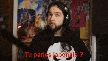 a man with long hair and a beard wearing headphones says tu parles japonais