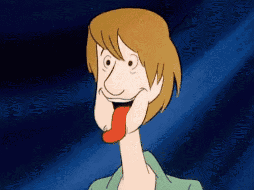 scooby doo is sticking his tongue out and smiling .
