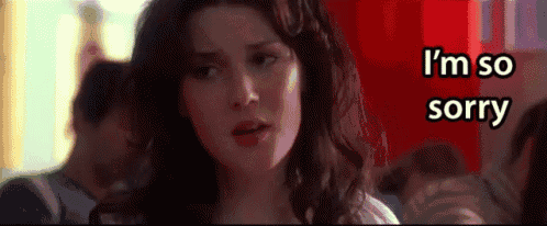 a woman says i 'm so sorry in front of a red box
