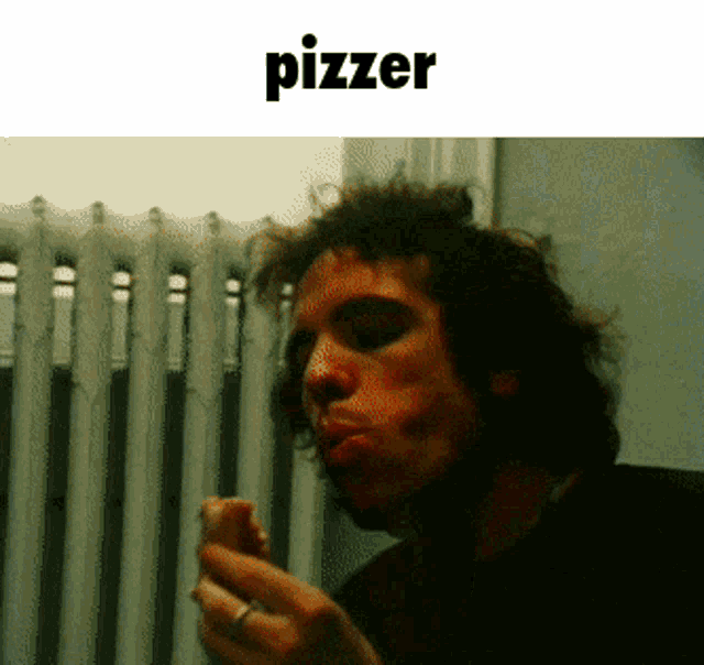 a man smoking a cigarette in front of a radiator with the word pizzer on the bottom