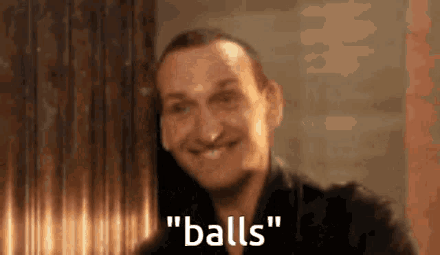a man is smiling and saying " balls " in a blurry photo