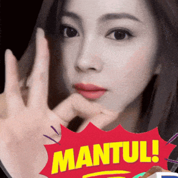 a woman 's face is behind a red sticker that says " mantul "