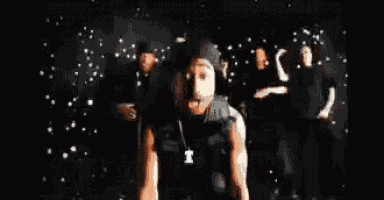 a blurry picture of a man dancing in front of a crowd