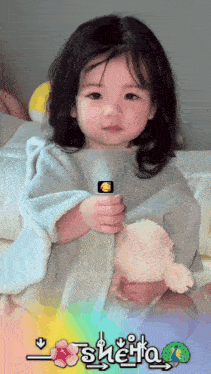 a little girl holding a stuffed animal with the name sheita on the bottom right