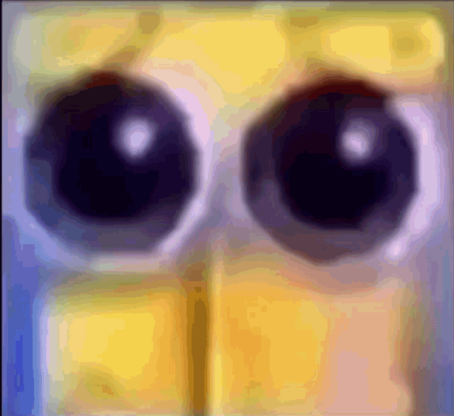 a close up of a cartoon character 's eyes with a yellow background