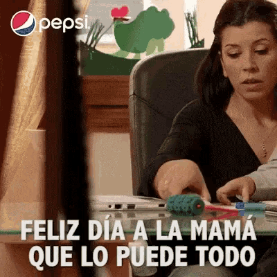 a pepsi ad shows a woman playing with a cat toy and says " feliz dia a la mama que lo puede todo "