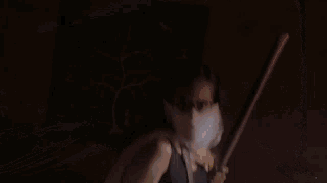 a man with a beard is standing in a dark room