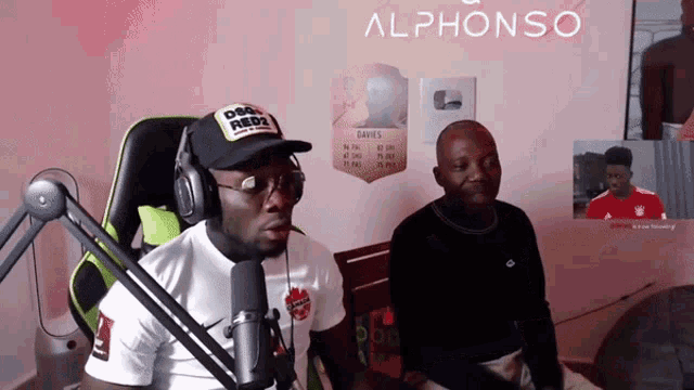 two men are sitting in front of a microphone with the word alphonso above them