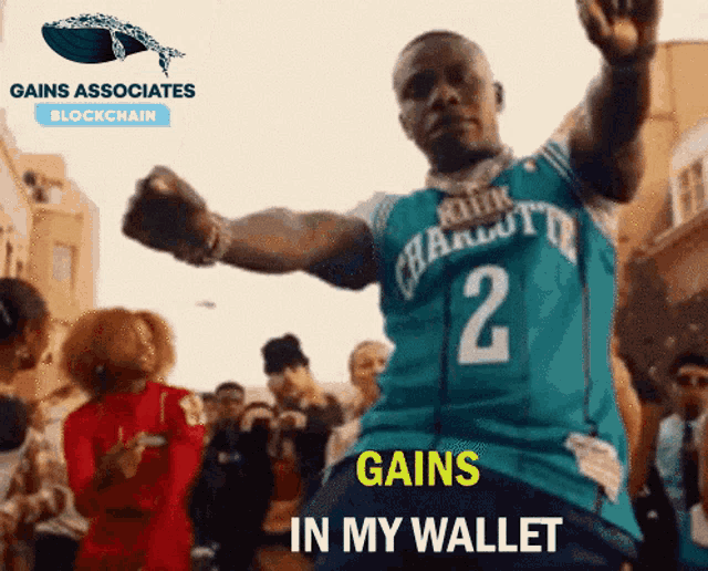 a man wearing a charlotte hornets jersey is dancing in front of a crowd
