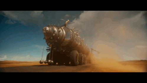 a very large vehicle is driving through a desert