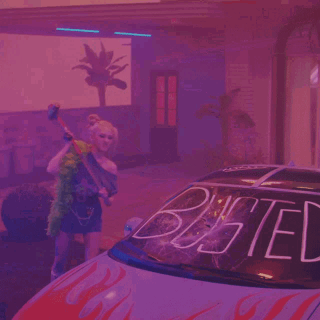 a woman in a feather boa is cleaning a car with a sledge hammer