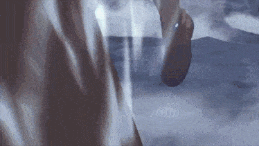 a close up of a person 's feet walking in the dark