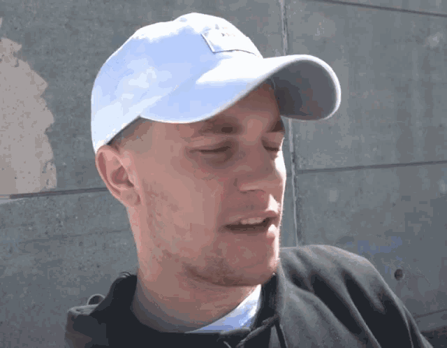 a man wearing a white hat that says ' a ' on it