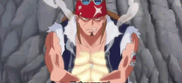 a man wearing a red hat and sunglasses is smoking a cigarette while standing in front of a rock wall .