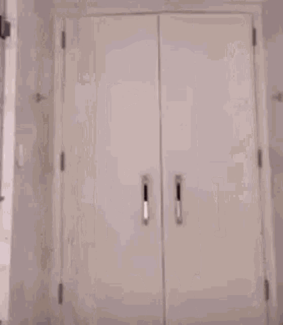 a man is standing in a doorway in a room .