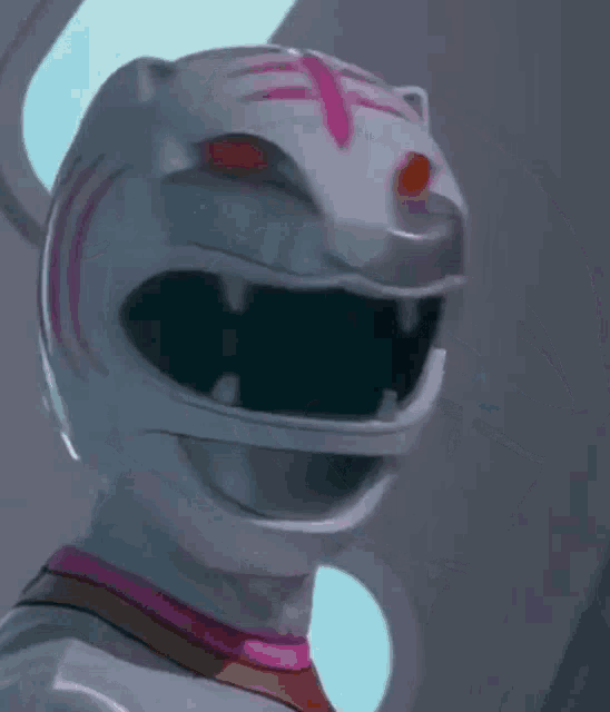 a close up of a white power ranger with a pink stripe on the helmet .