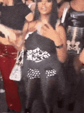 a woman is standing in a crowd of people holding a shirt that says `` i 'm not a fan '' .