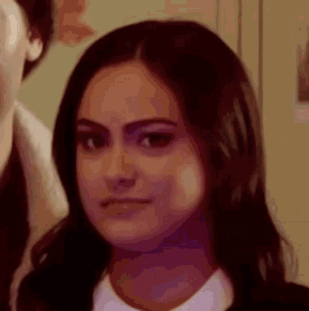 a close up of a woman 's face with a serious expression .