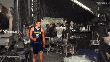 a denver basketball player is running on stage